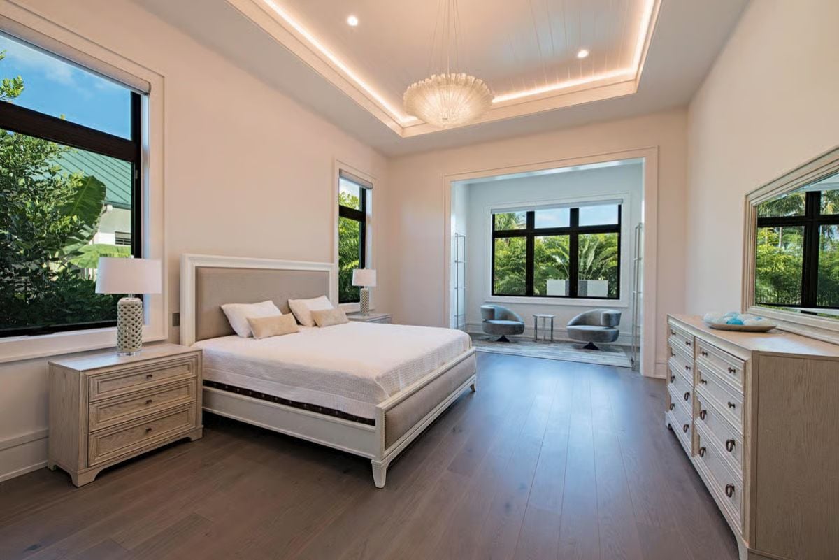 Tray Ceiling, Sitting Alcove, and Warm Wood Floors Make This Primary Suite Feel Like a Private Retreat