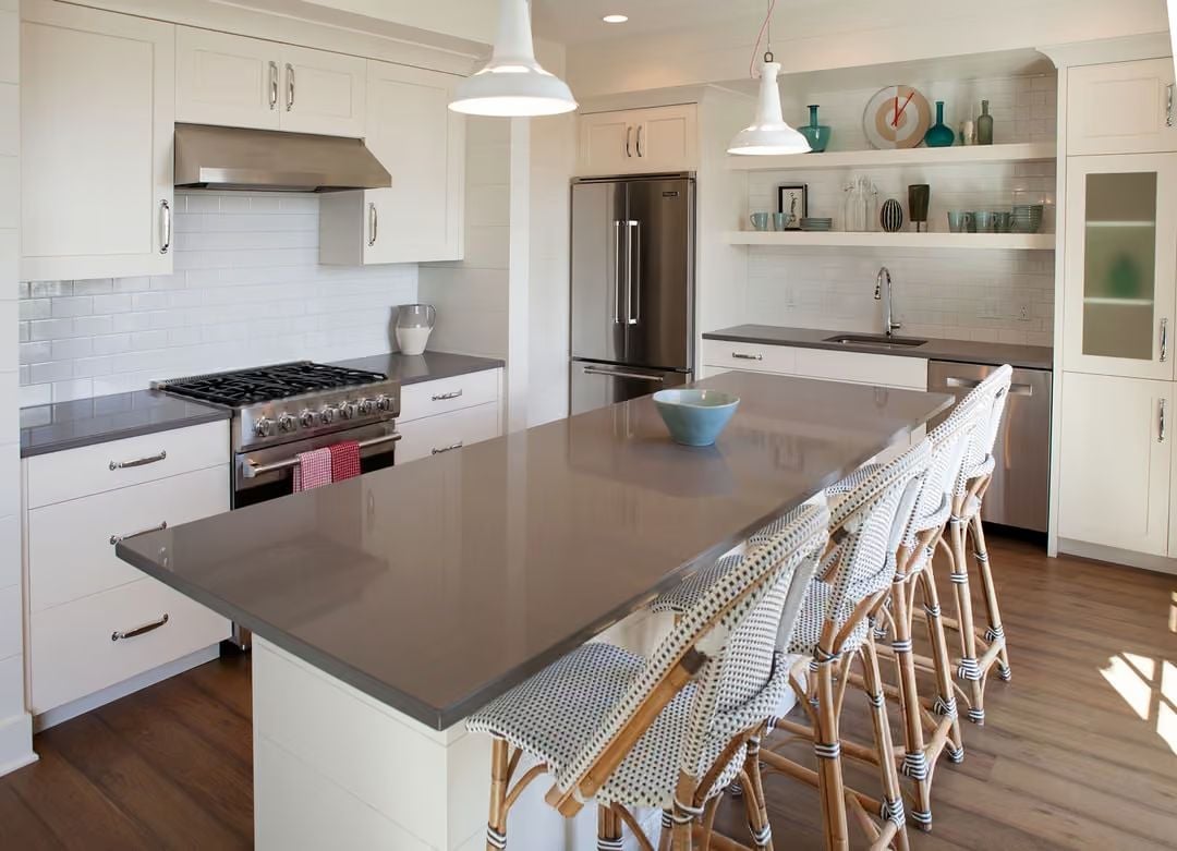 Gray Quartz, Rattan Barstools, and a Kitchen That Earns Its Open Concept