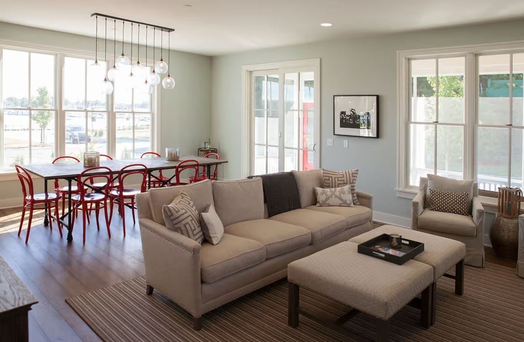 Nailhead Trim, Globe Pendants, and Red Chairs That Own the Room