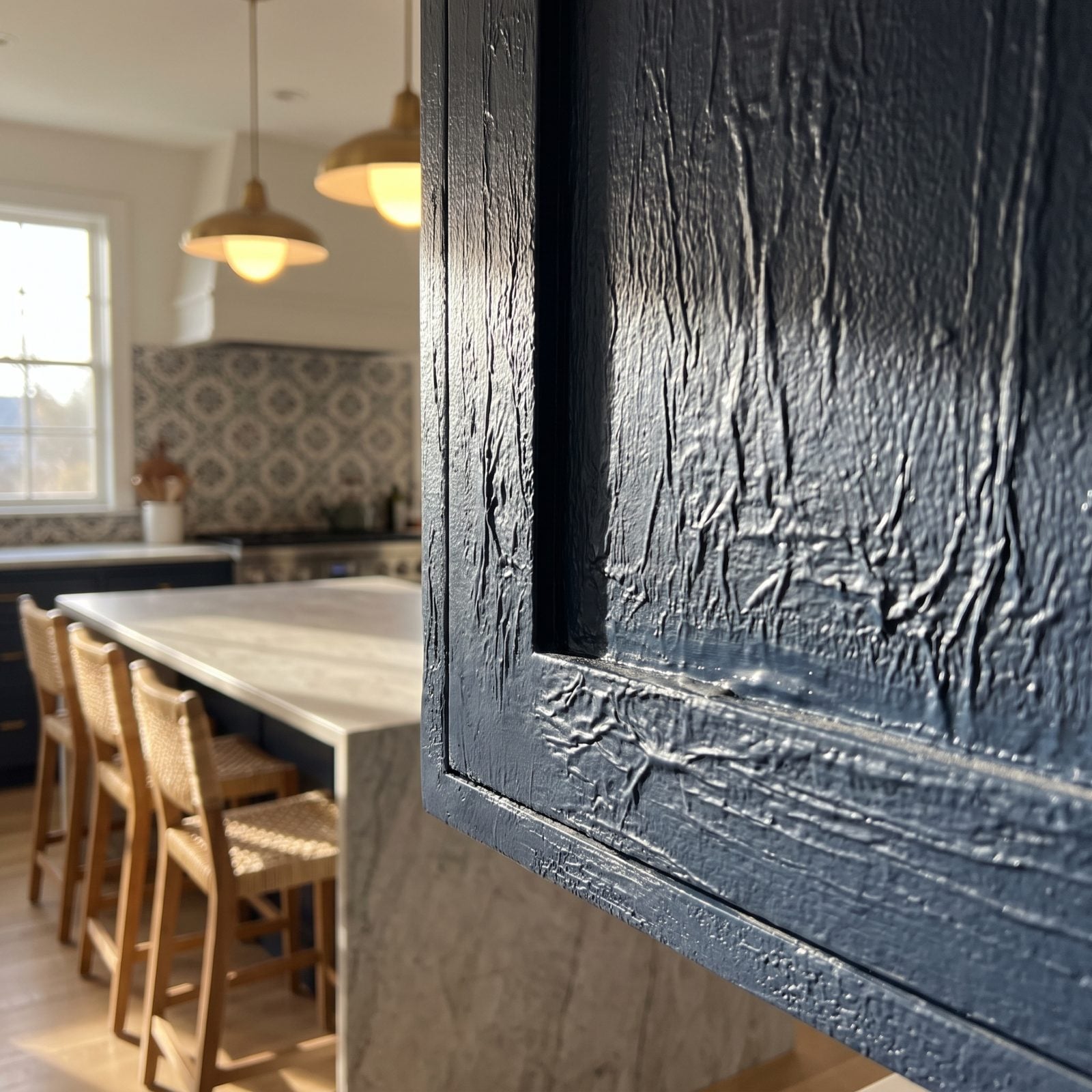 Navy cabinet corner with orange-peel texture and a wrinkled sag from one thick coat of paint.