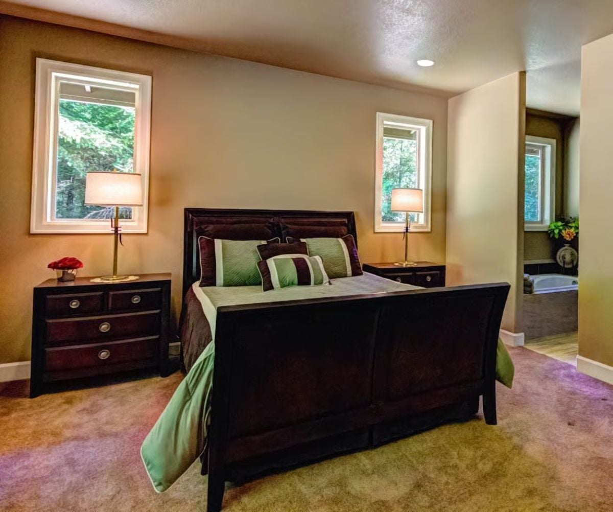 Sage Green Bedding Against Espresso Wood Is a Combination That Actually Holds Up