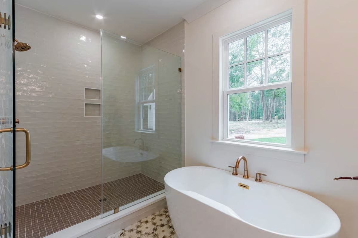 Freestanding Tub by the Window, Glass Enclosure, and Gold Fixtures That Earn Their Keep