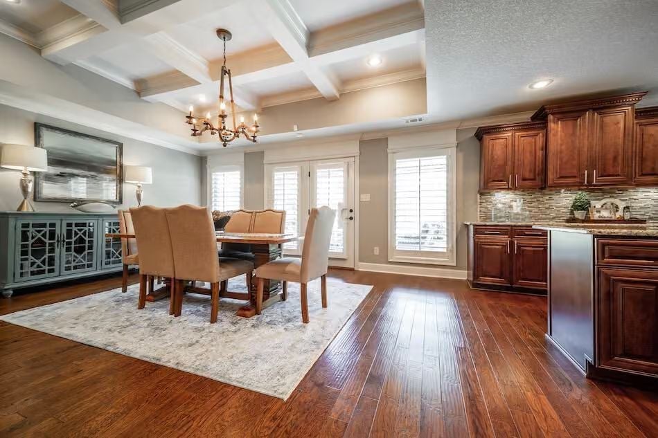 Coffered Ceiling and Rich Wood Cabinets That Make the Open Plan Feel Intentional