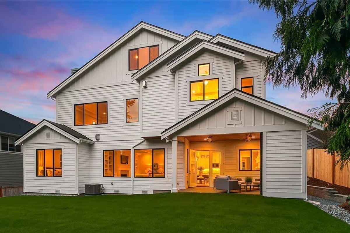 Warm Light Pours Through Every Window as Dusk Settles Behind the Roofline