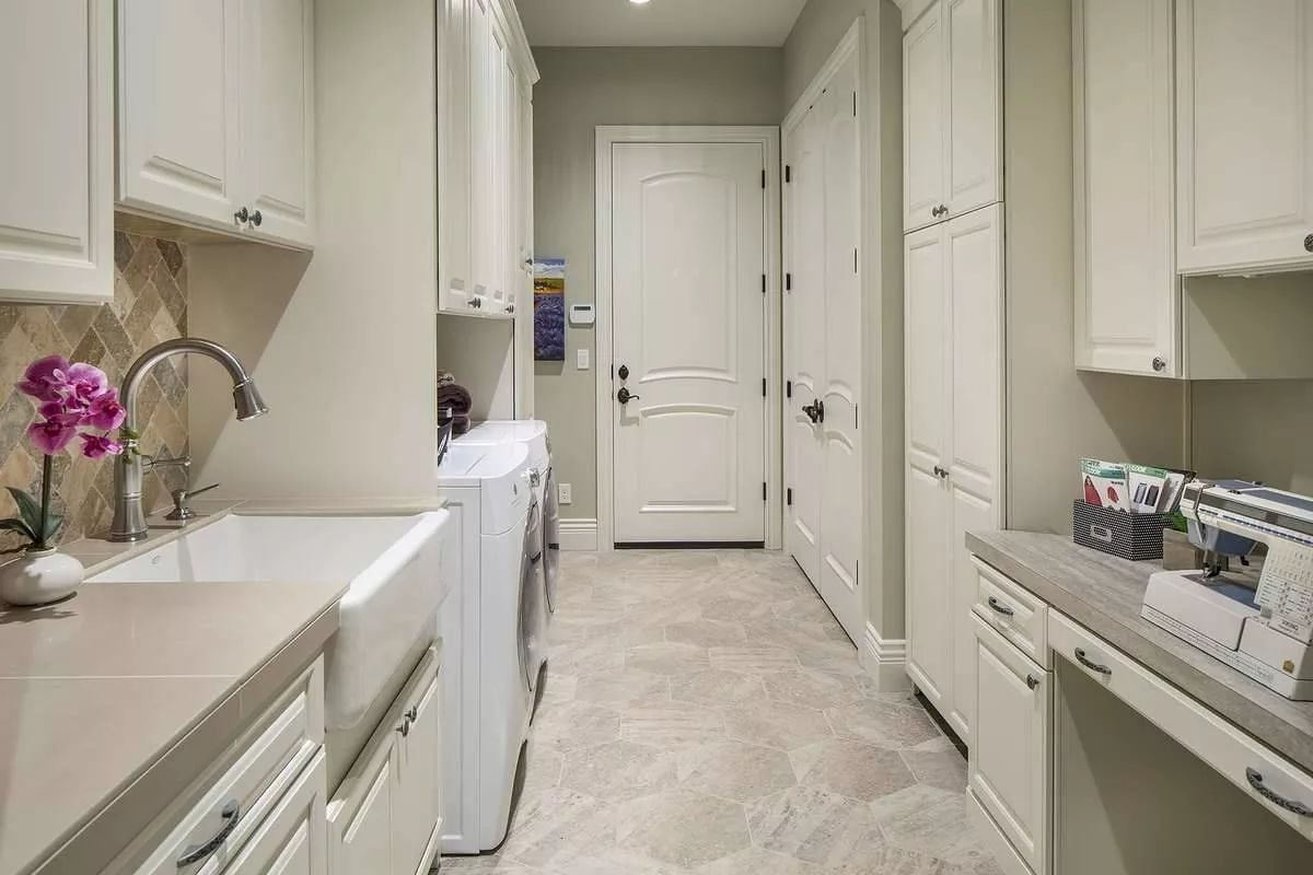 Farmhouse Sink, Washer-Dryer, and Sewing Station Walk Into a Laundry Room