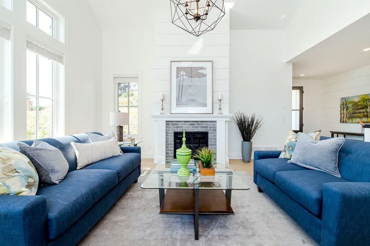 Navy Sofas and a Glass Table That Don't Apologize for Taking Up Space