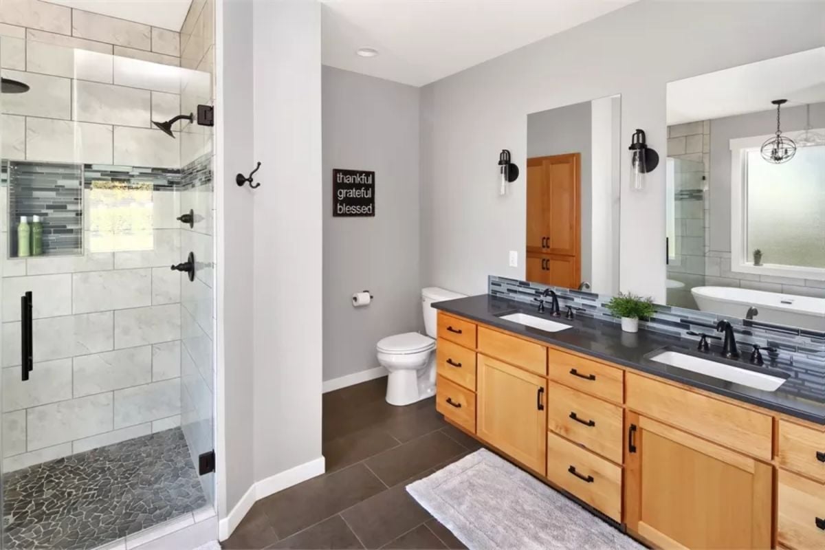 Honey-Toned Vanity, Dark Counters, and a Shower Built for Two