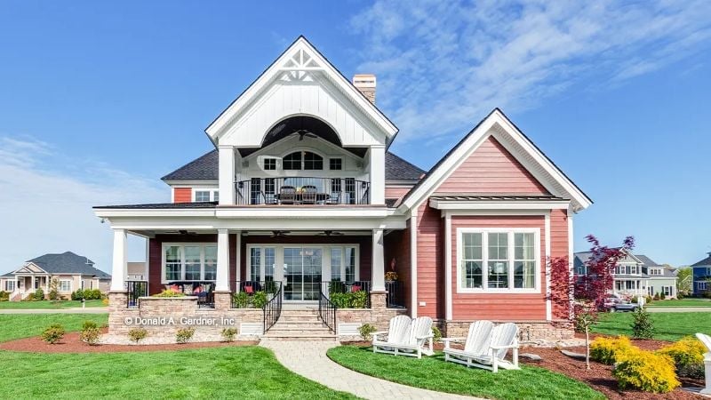 Red Board-and-Batten Exterior with a Second-Floor Balcony Built for Sunsets