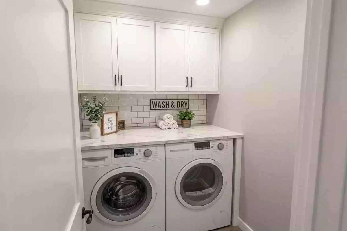 Marble Countertop Over the Machines and Subway Tile That Earns Its Place