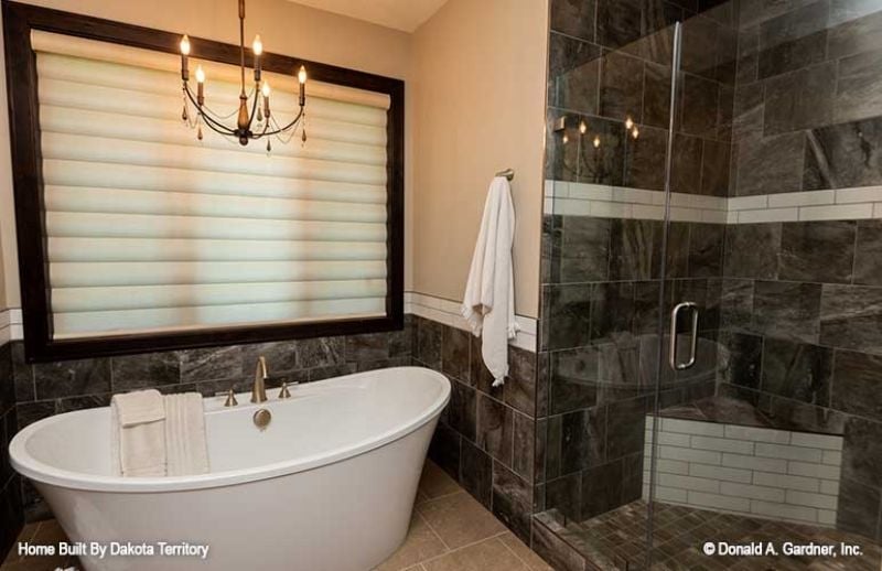 Freestanding Tub, Chandelier, and Dark Tile That Earns Its Place