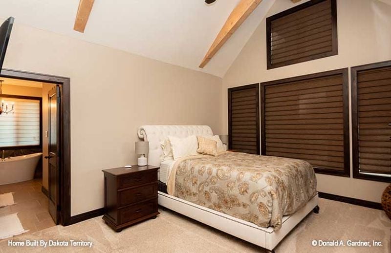 Vaulted Ceiling, Tufted Headboard, and Shutters That Do the Heavy Lifting