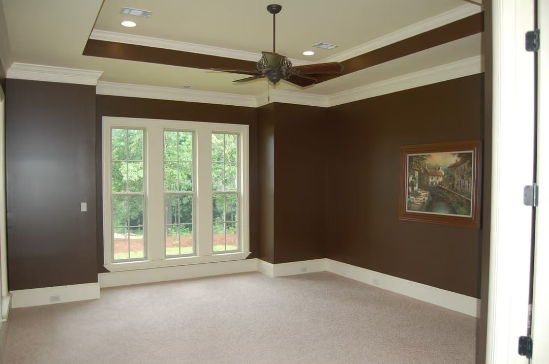 Chocolate Walls and a Tray Ceiling Give This Empty Room More Presence Than Most Furnished Ones