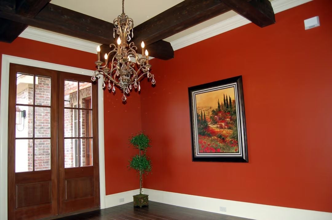 Red Walls and Exposed Beams Set a Tuscan Tone at the Entry