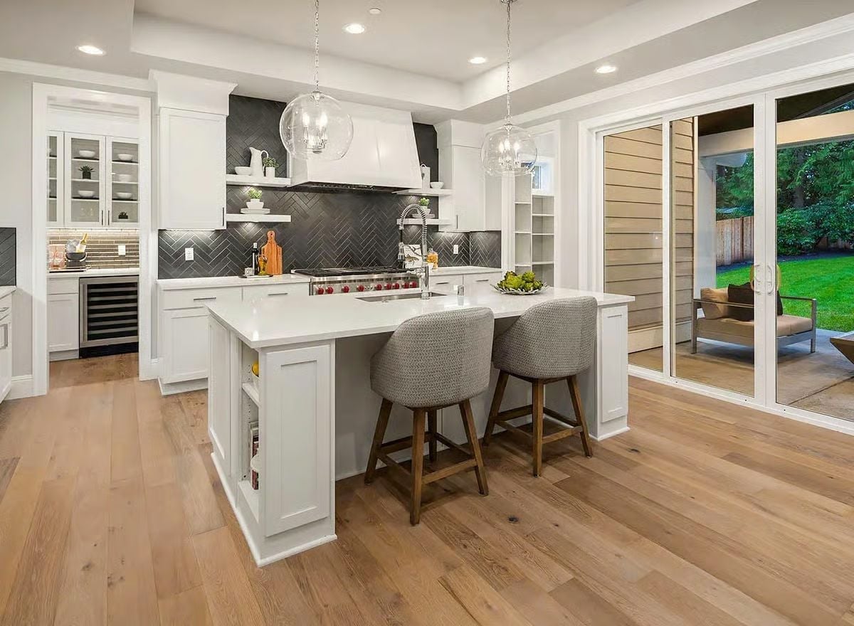 Herringbone Backsplash, Globe Pendants, and an Island Built for Two