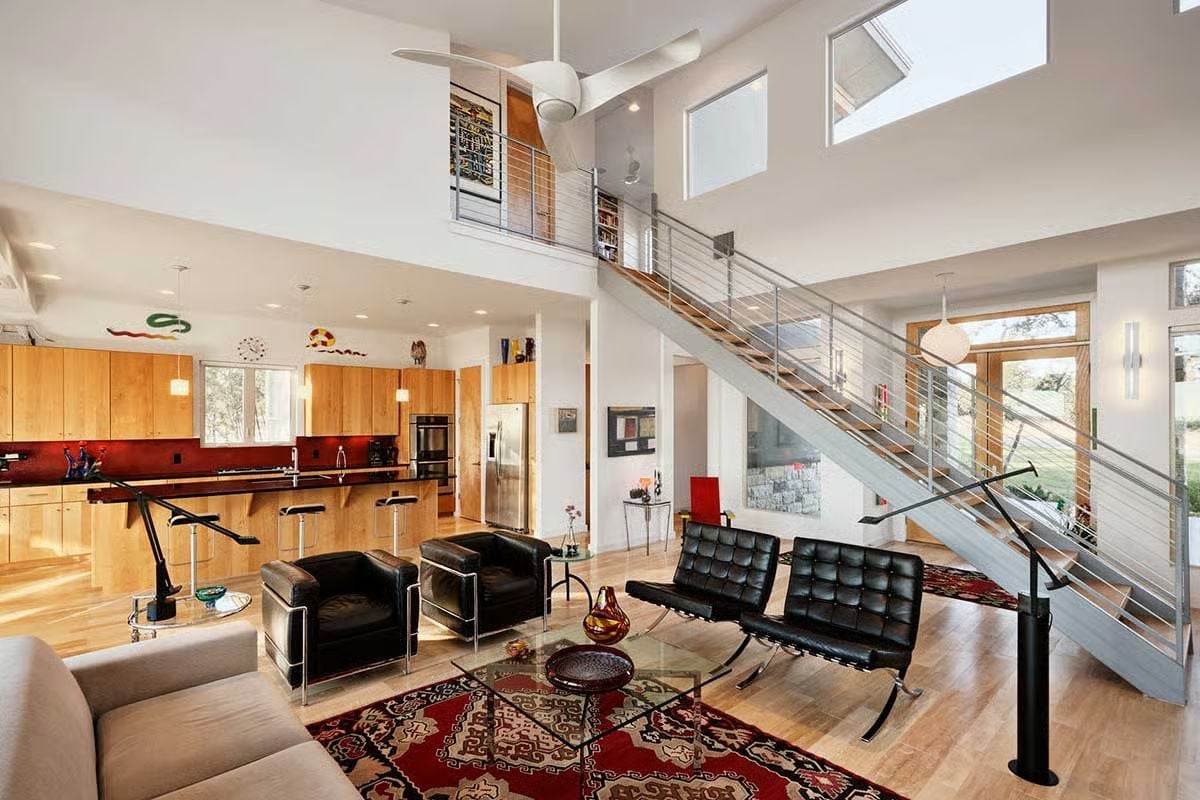 Double-Height Living Room Where the Staircase Earns Its Place as Furniture