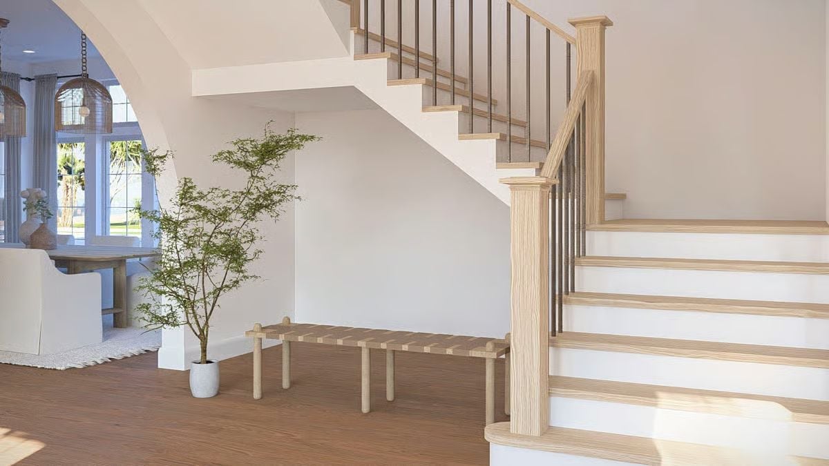 Light Wood and Metal Balusters Pull This Entryway Staircase Together