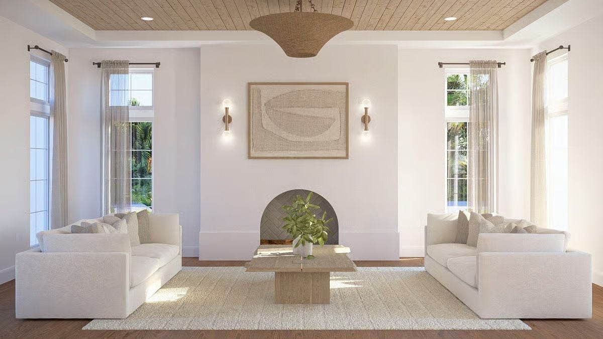 Paired Sofas and an Arched Fireplace Give This Living Room Its Backbone
