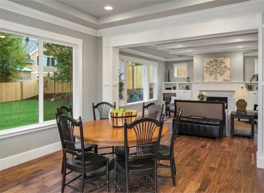 Round Table, Black Chairs, and a Backyard That Pulls Your Eyes Right Through