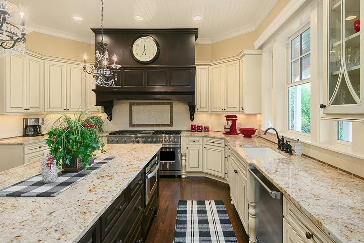 Dark Vent Hood with a Clock Built In Makes the Stove Feel Like a Statement