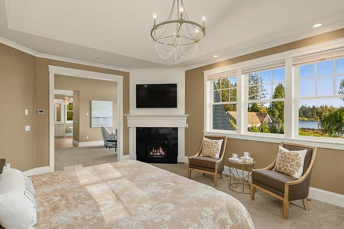 Fireplace, Flat-Screen, and a Water View All Compete for Attention in This Master Suite