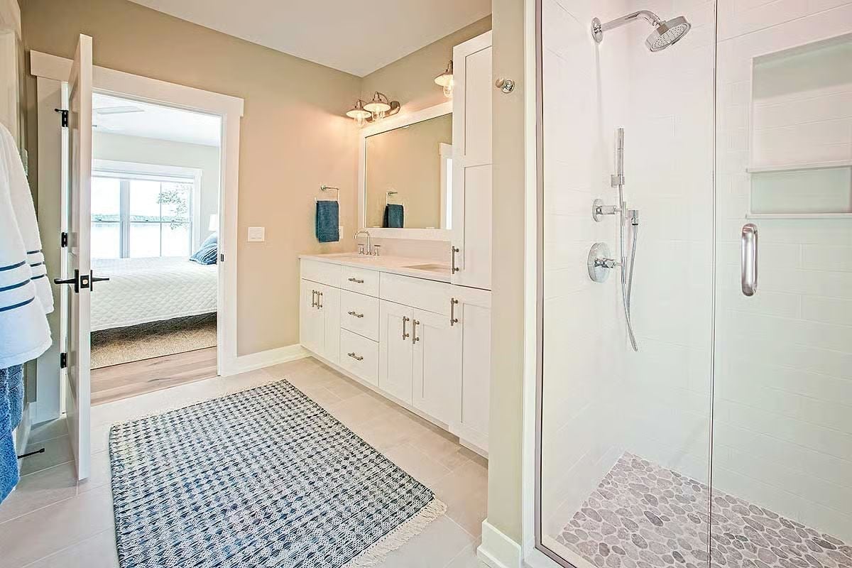 Pebble-Floor Shower and White Shaker Vanity Built for Post-Lake Cleanup