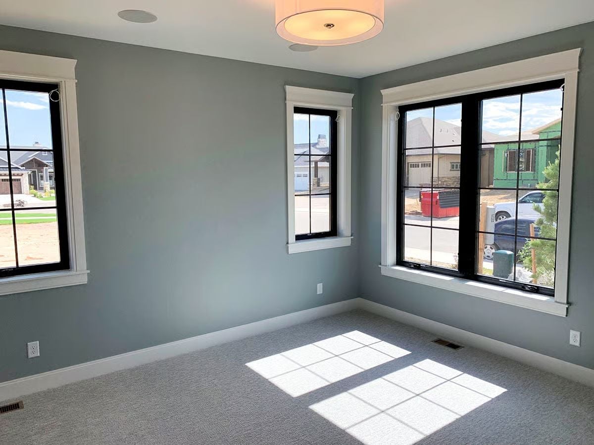 Gray Carpet, Black Window Grilles, and Sunlight Doing the Heavy Lifting
