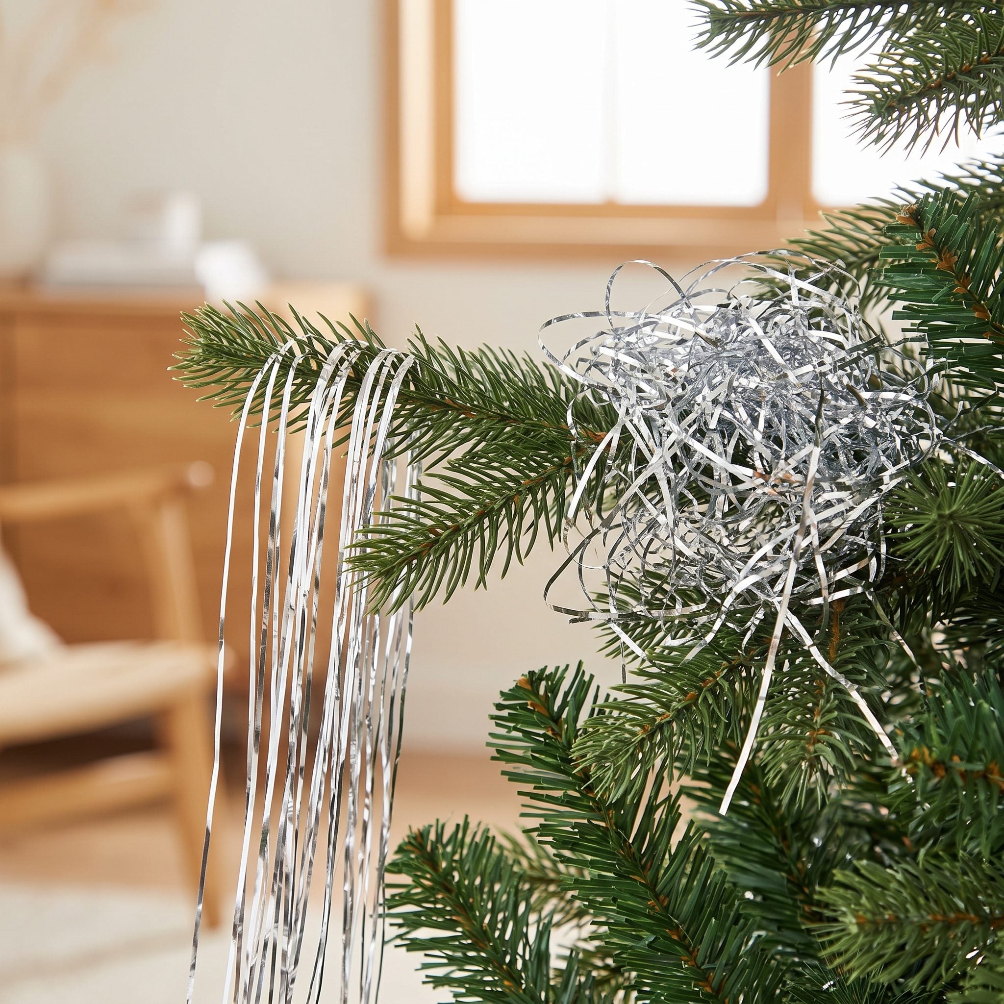 Silver Tinsel Draped Over the Branches, One Strand at a Time