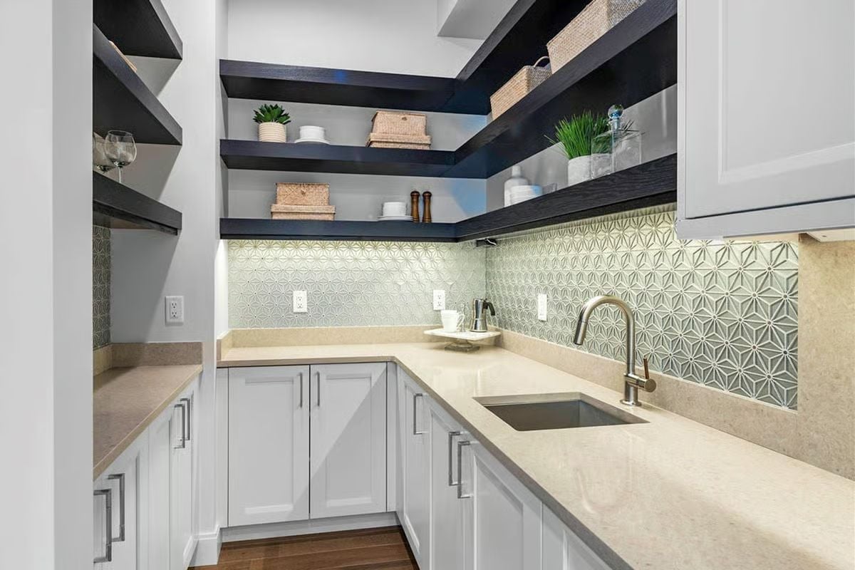 Dark Floating Shelves Anchored Over a Star-Pattern Backsplash Pull This Pantry Together