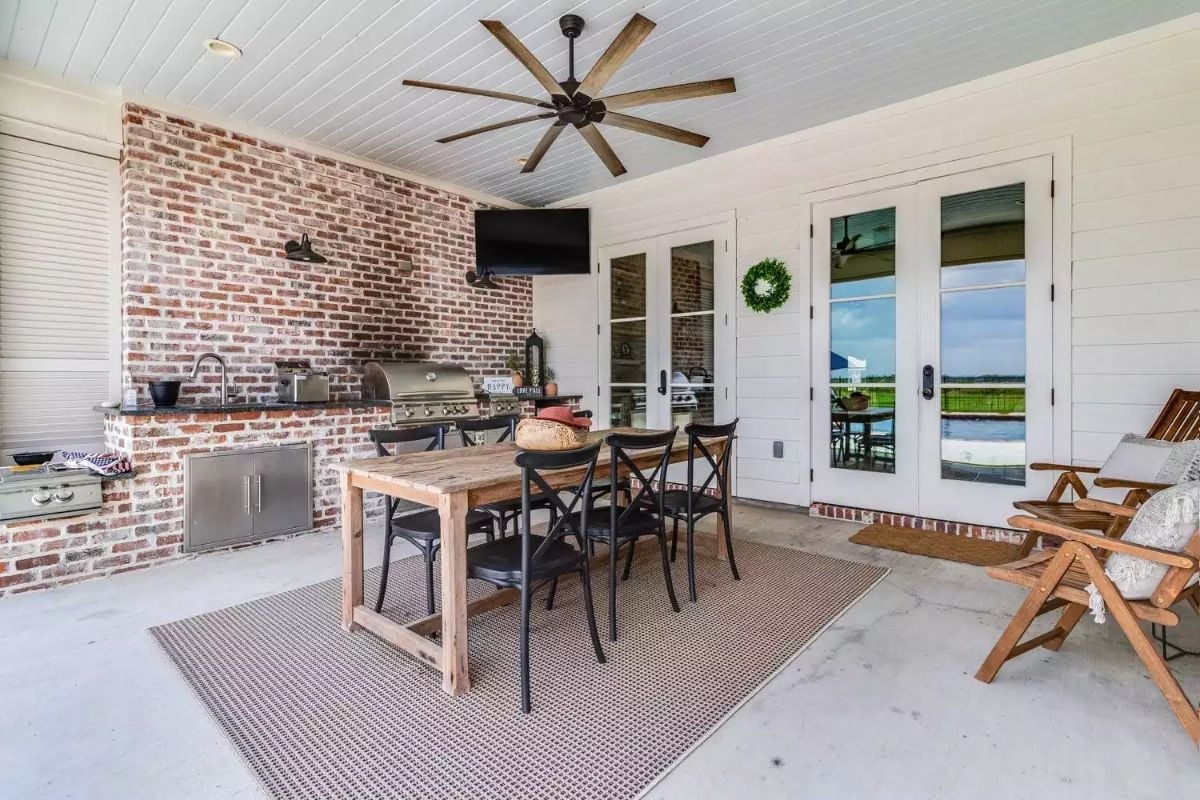 Brick Kitchen Wall and a Ceiling Fan Built for Outdoor Living