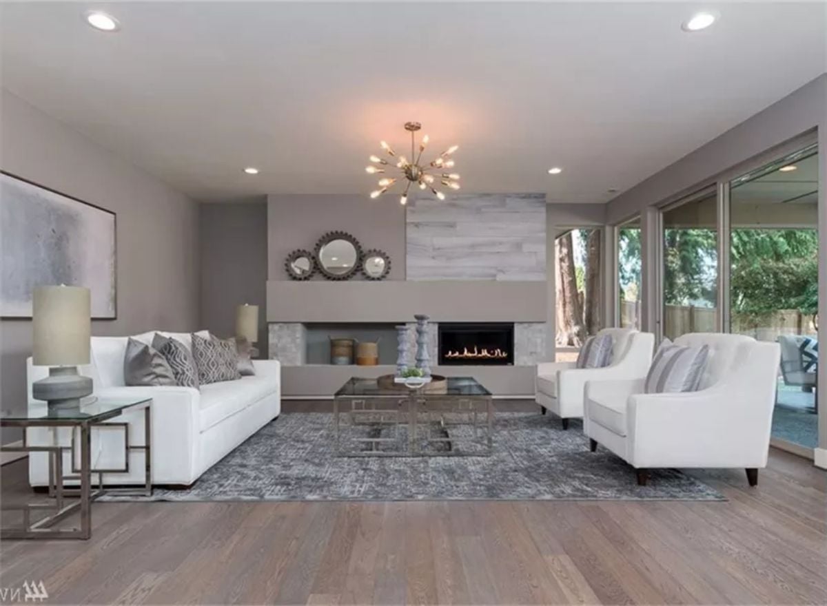 Sputnik Chandelier, White Sofas, and a Fireplace Wall That Actually Commits