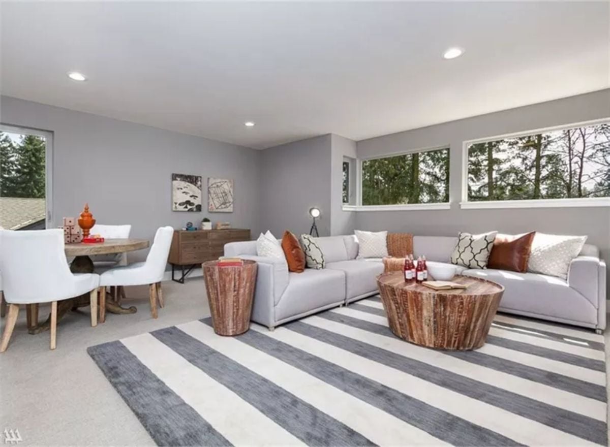 Striped Rug, Tree Line Views, and Two Tree-Stump Tables That Anchor the Sectional