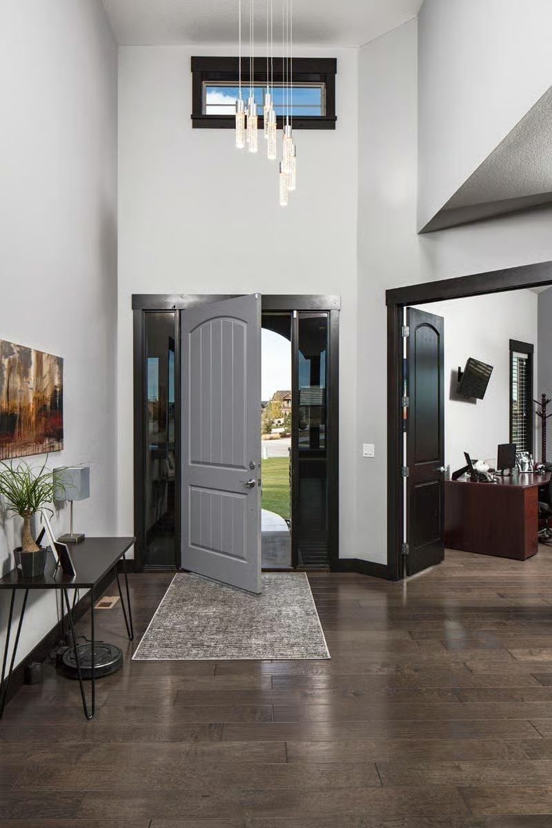 Pivot-Hinged Entry With Two-Story Ceilings Built to Make an Impression