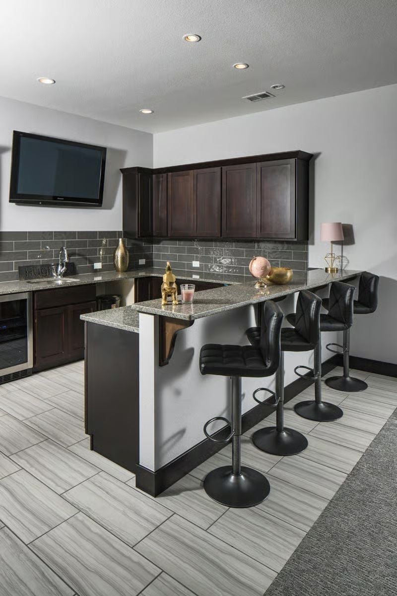 Wet Bar With Granite Overhang Built for Hosting That Runs Past Midnight