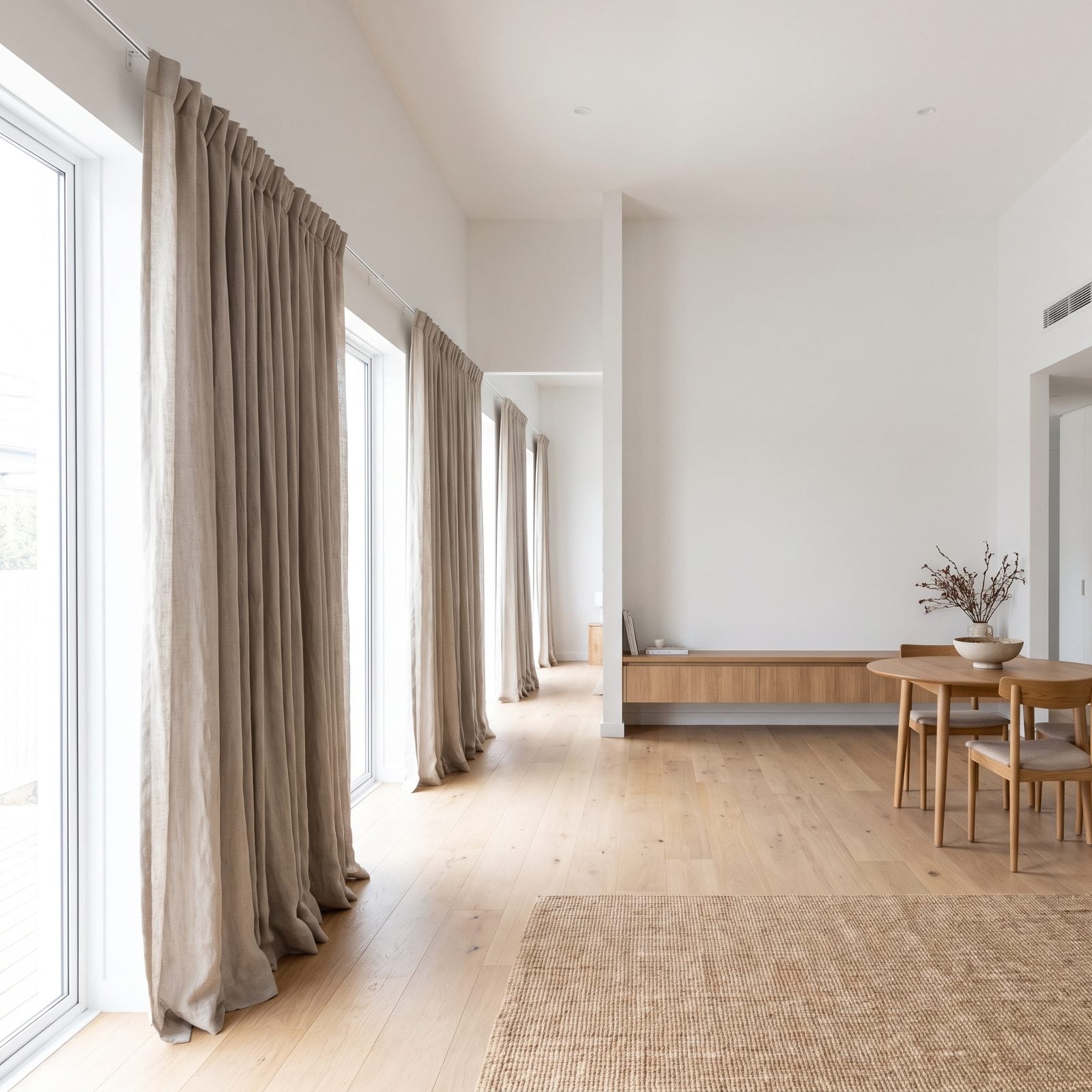 Small Apartment With Ceiling-High Curtains Spanning the Entire Window Wall