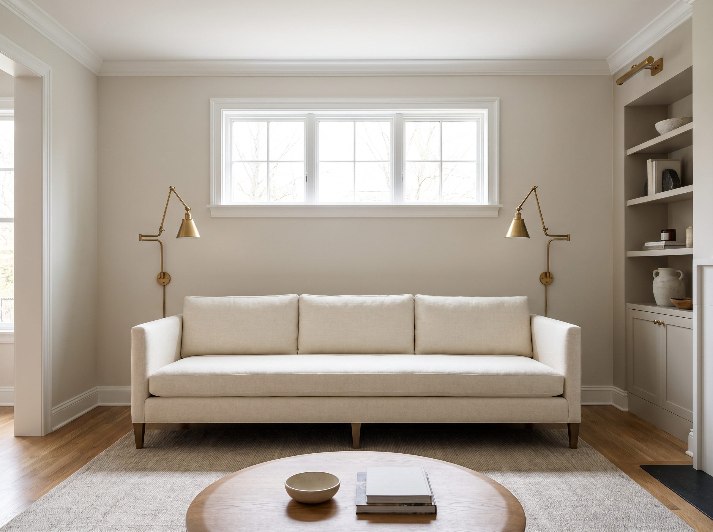 Living room with a 34-inch-tall sofa against the far wall beneath a picture window whose sill sits about 40 inches off the