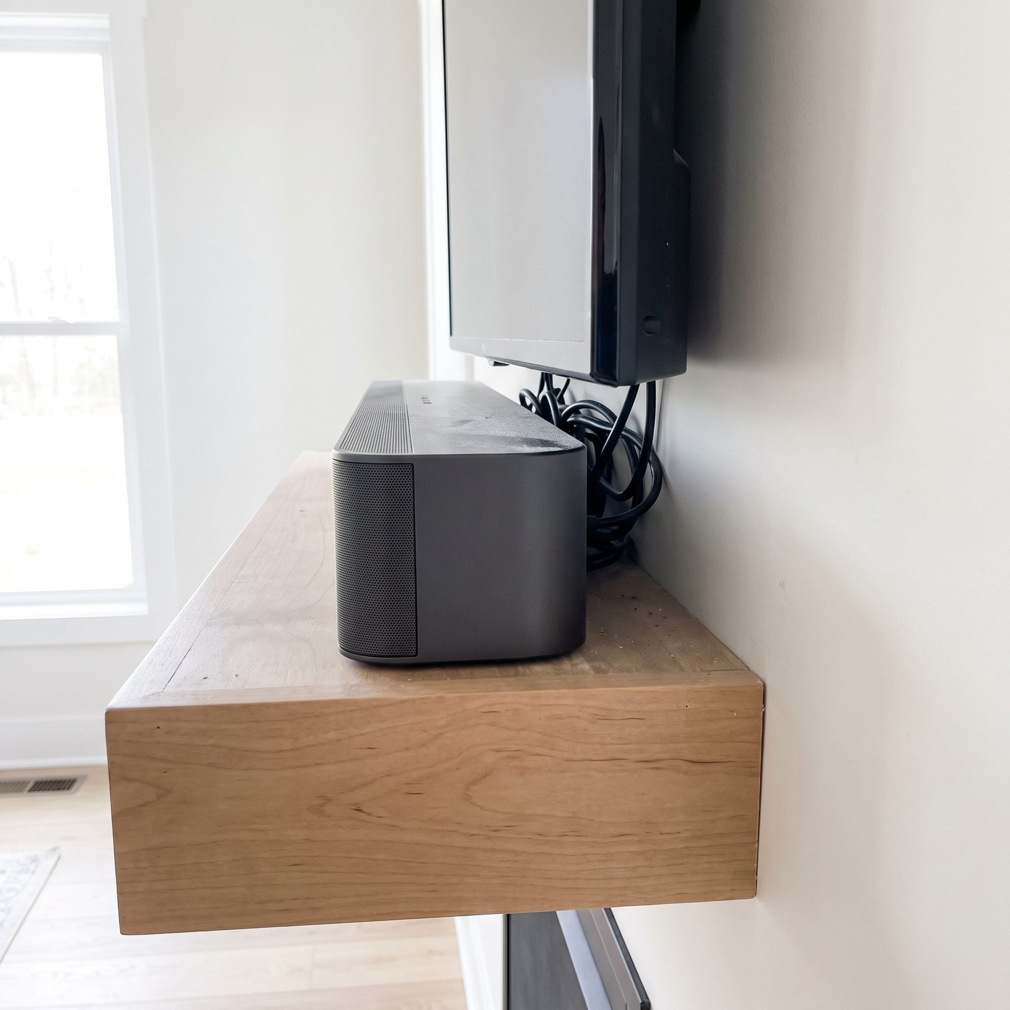 The Soundbar Squeezed Between the Mantel and Television