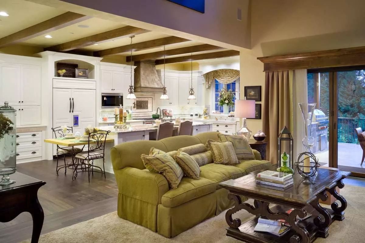 Olive Green Sofa and Exposed Beams Set the Tone in This Open-Plan Living Space