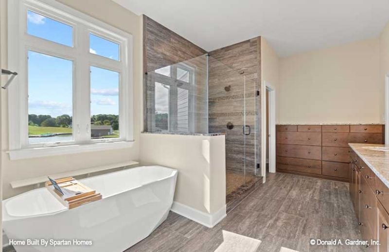 Freestanding Tub Parked Under a Triple Window With a View Worth Soaking In