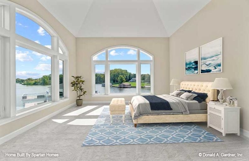 Lakefront Bedroom With Arched Windows Doing More Work Than the Decorator