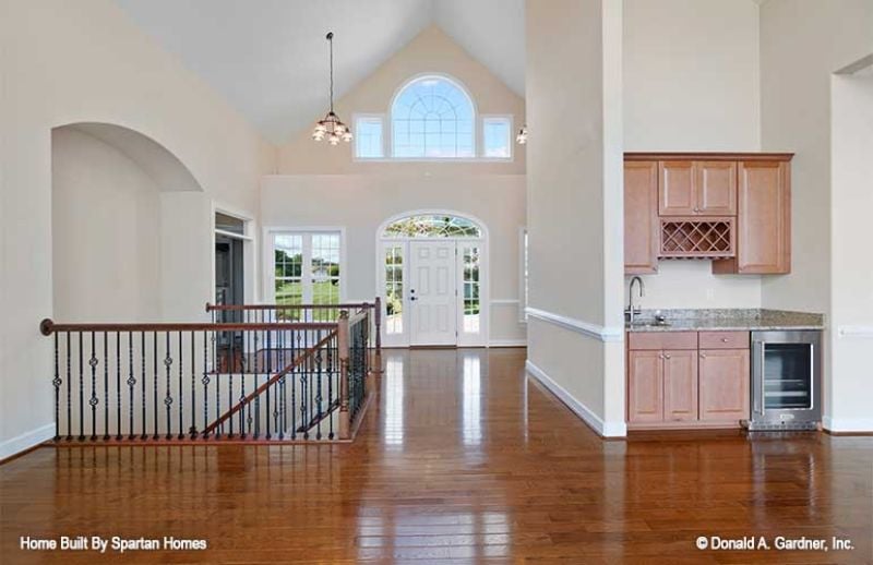 Vaulted Entry Hall With a Wine Rack Built Into the Kitchen Wall Like It Belongs There