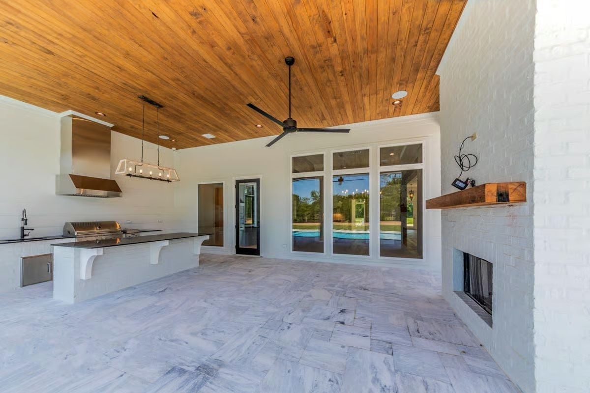 Covered Rear Porch Pulls Off Outdoor Kitchen, Fireplace, and Pool Views All at Once