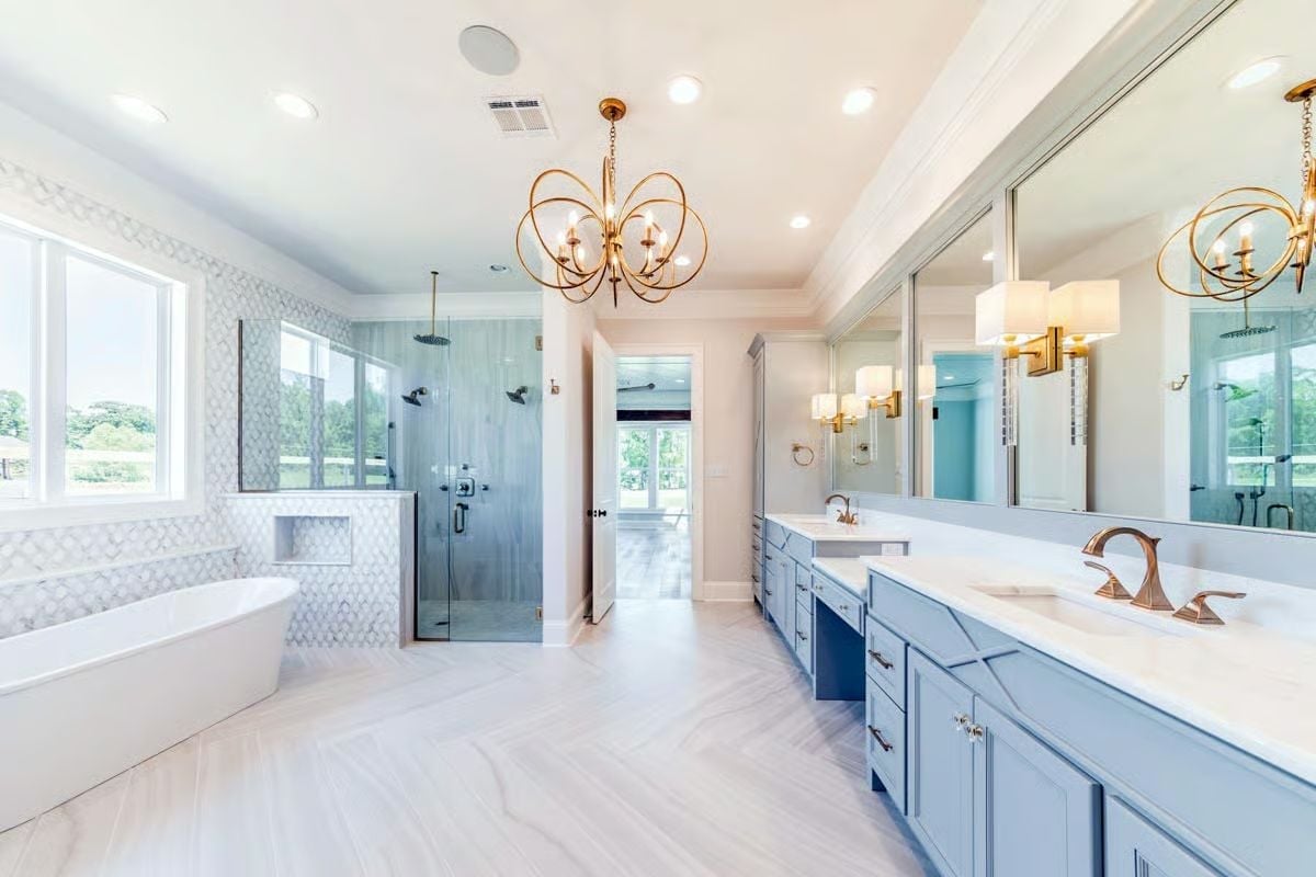 Gold Chandelier and Blue Cabinetry Make This Master Bath Worth Waking Up For