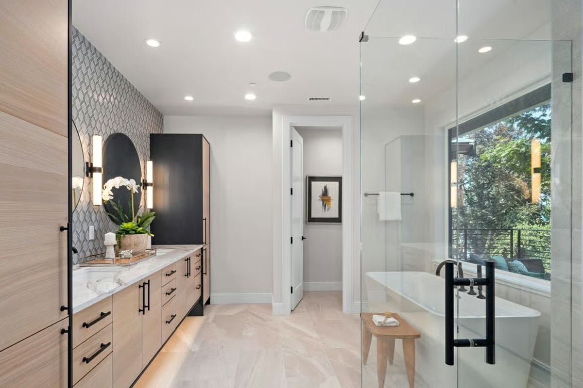 Arched Mirror and Herringbone Tile Make This Vanity Wall Work Harder Than Expected