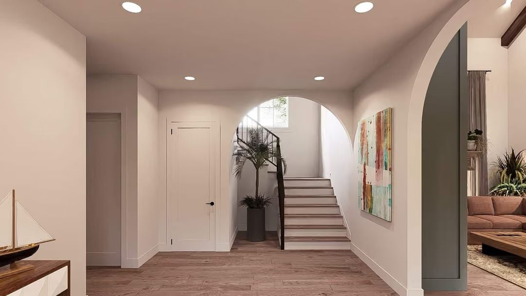 Arched Doorways and Warm Wood Floors That Set the Tone Before You Reach the Stairs