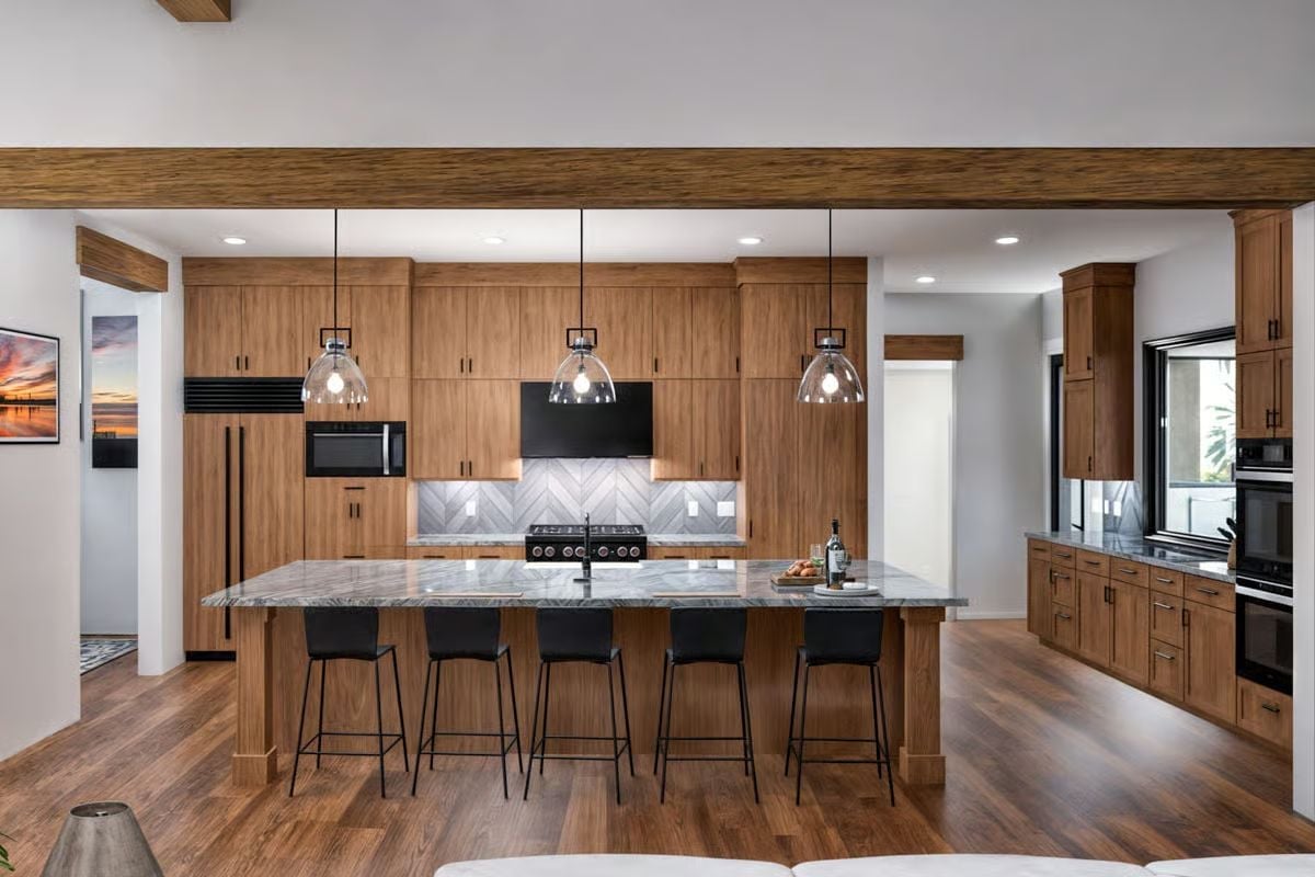 Walnut Cabinets, Marble Island, and Pendant Lights That Know Their Place