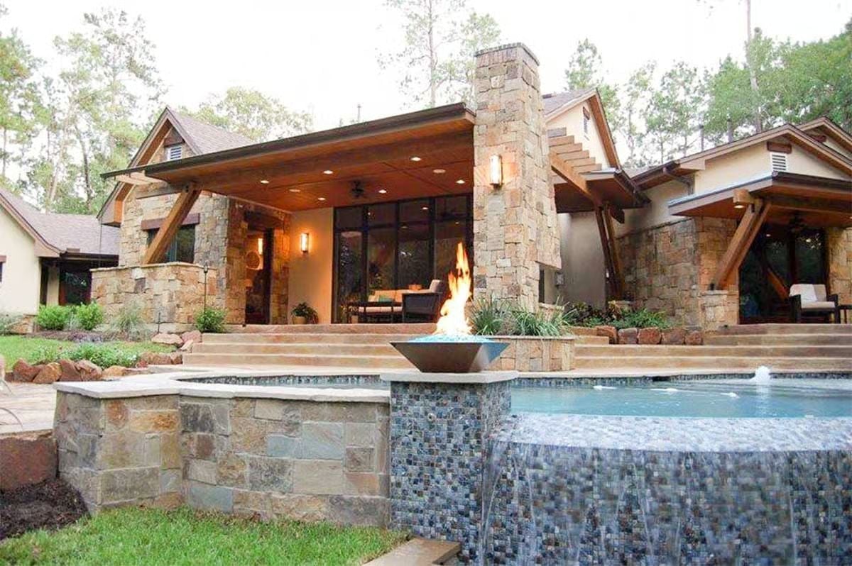 Stone Columns, an Open Flame, and a Pool That Cascades Like It Means It