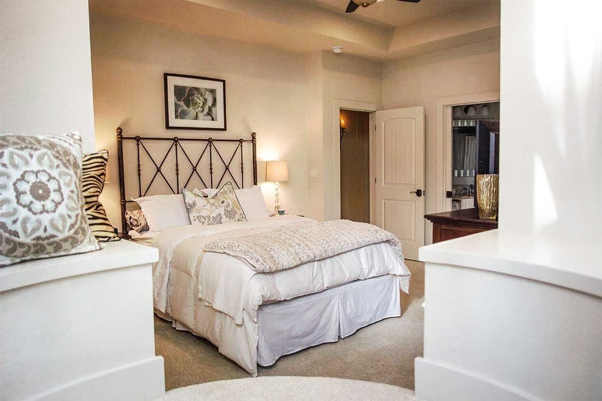 Wrought Iron, White Linen, and a Headboard That Doesn't Need Explaining