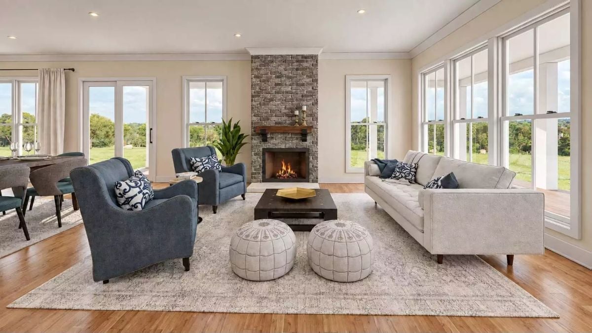 Brick Fireplace, Blue Armchairs, and Windows That Bring the Pasture Inside