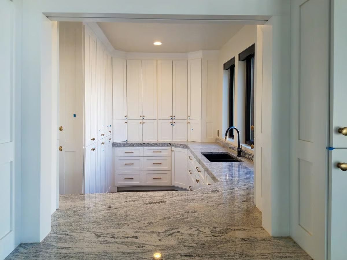 Marble Counters That Wrap a Full Butler's Pantry Corner-to-Corner