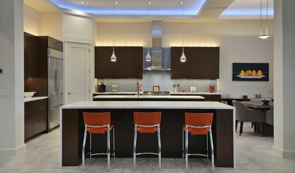 Chrome Pendants and Orange Barstools Pull This Kitchen Away From Playing It Safe